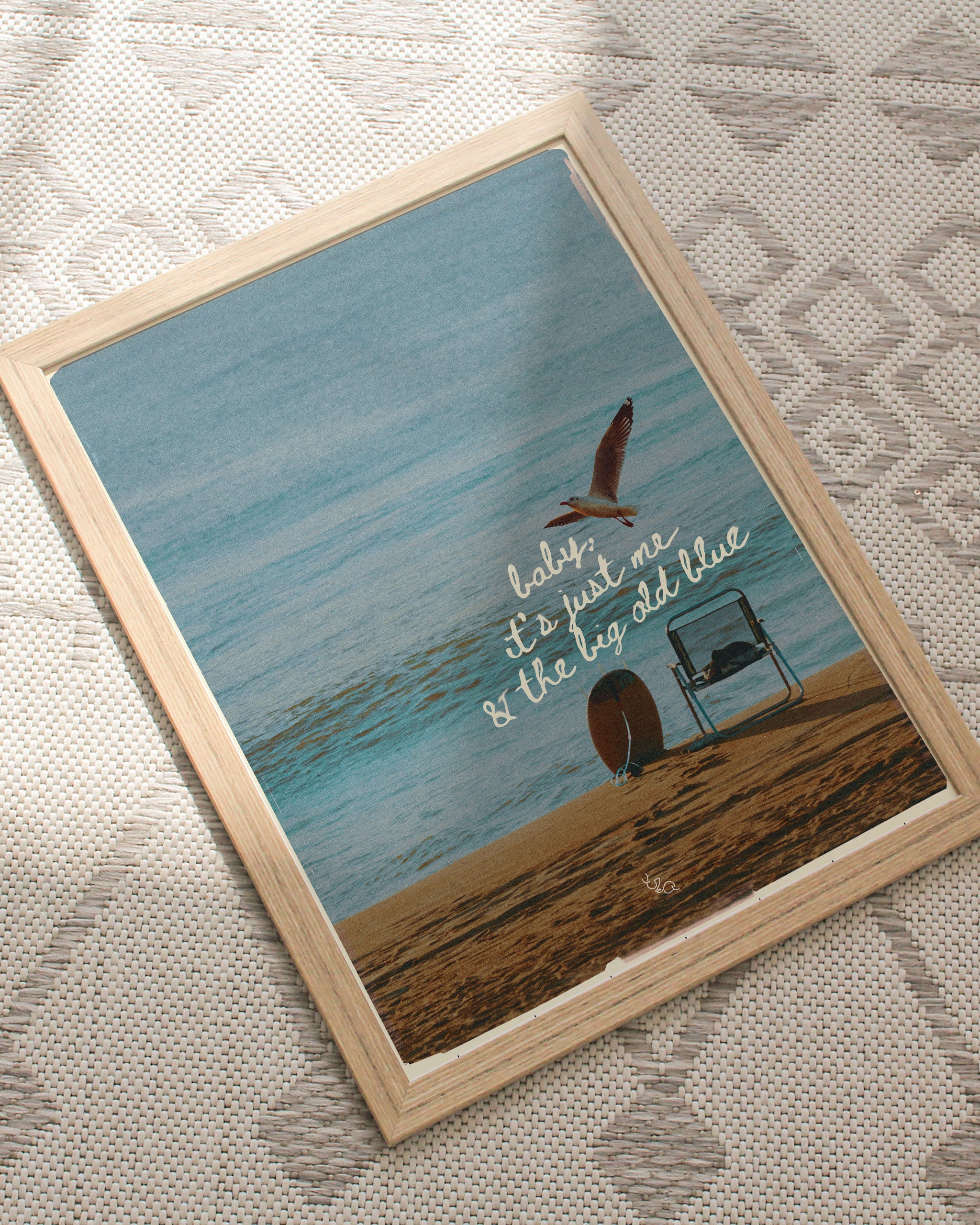 Framed beach poster of a beach scene with a seagull and text on a textured surface