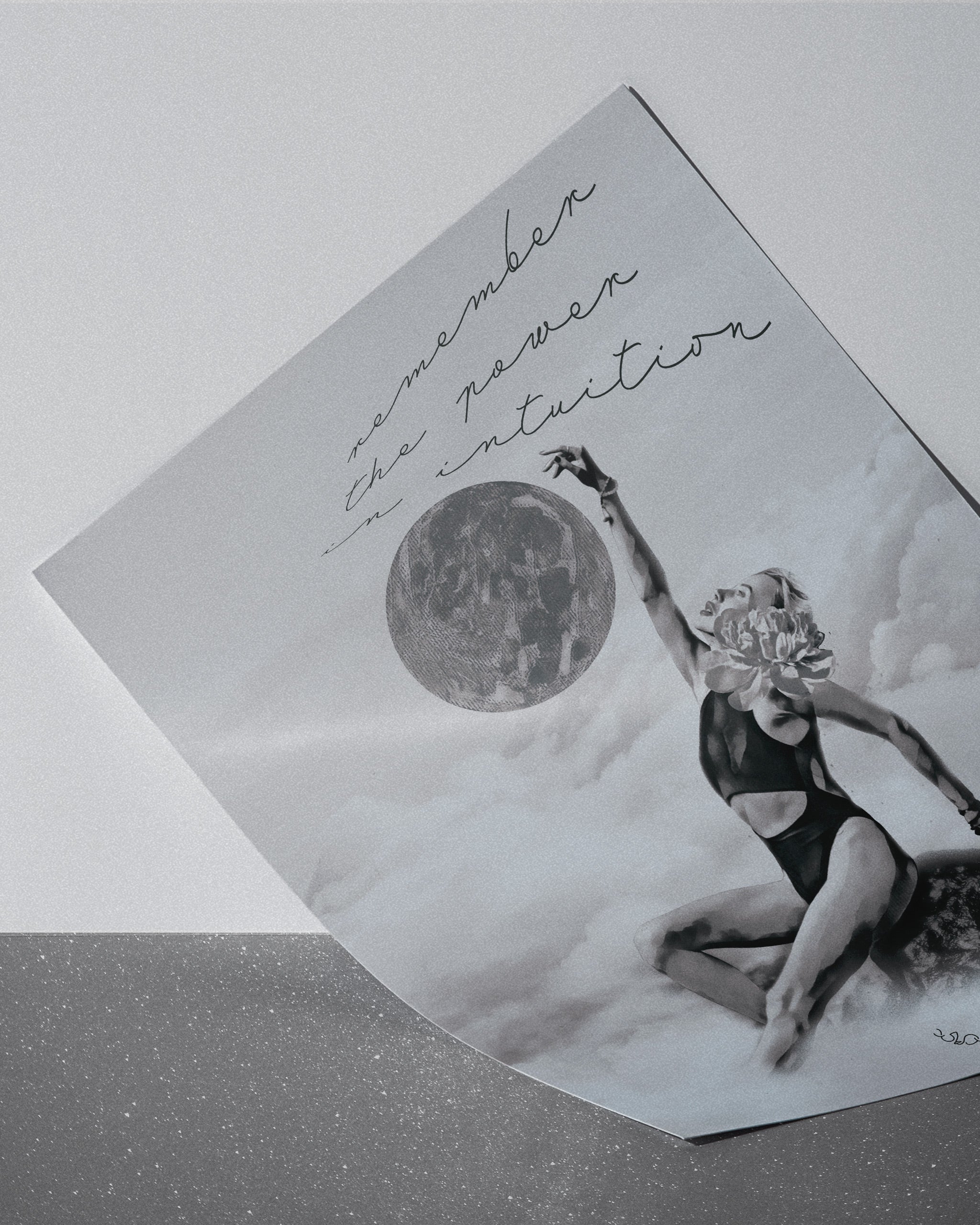 monochromatic wall art of a light shifter, a woman in a swimsuit and text 'Remember the power in intuition' on a textured surface.