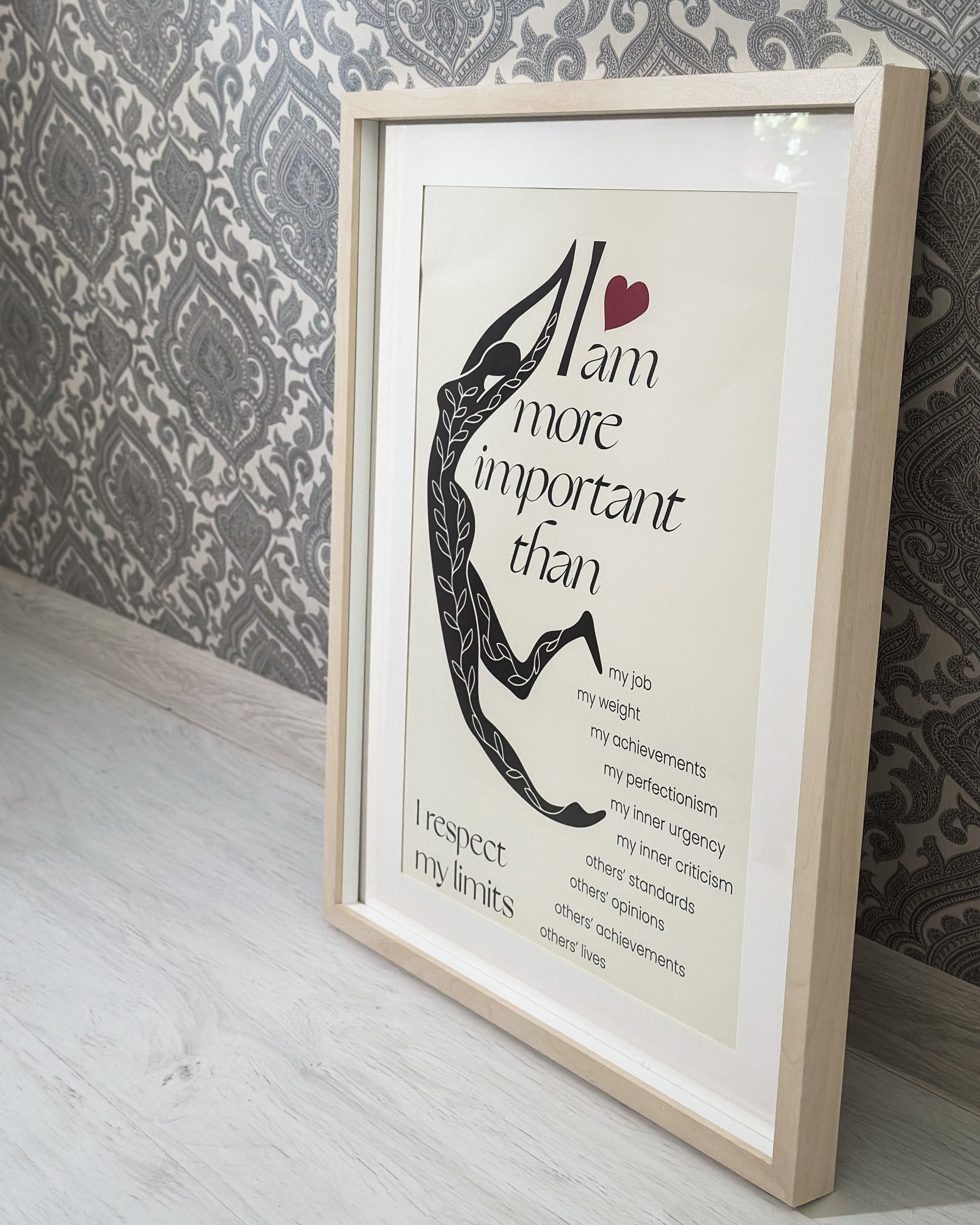 the perfectionist self love poster framed in a beige frame and shown by a wall