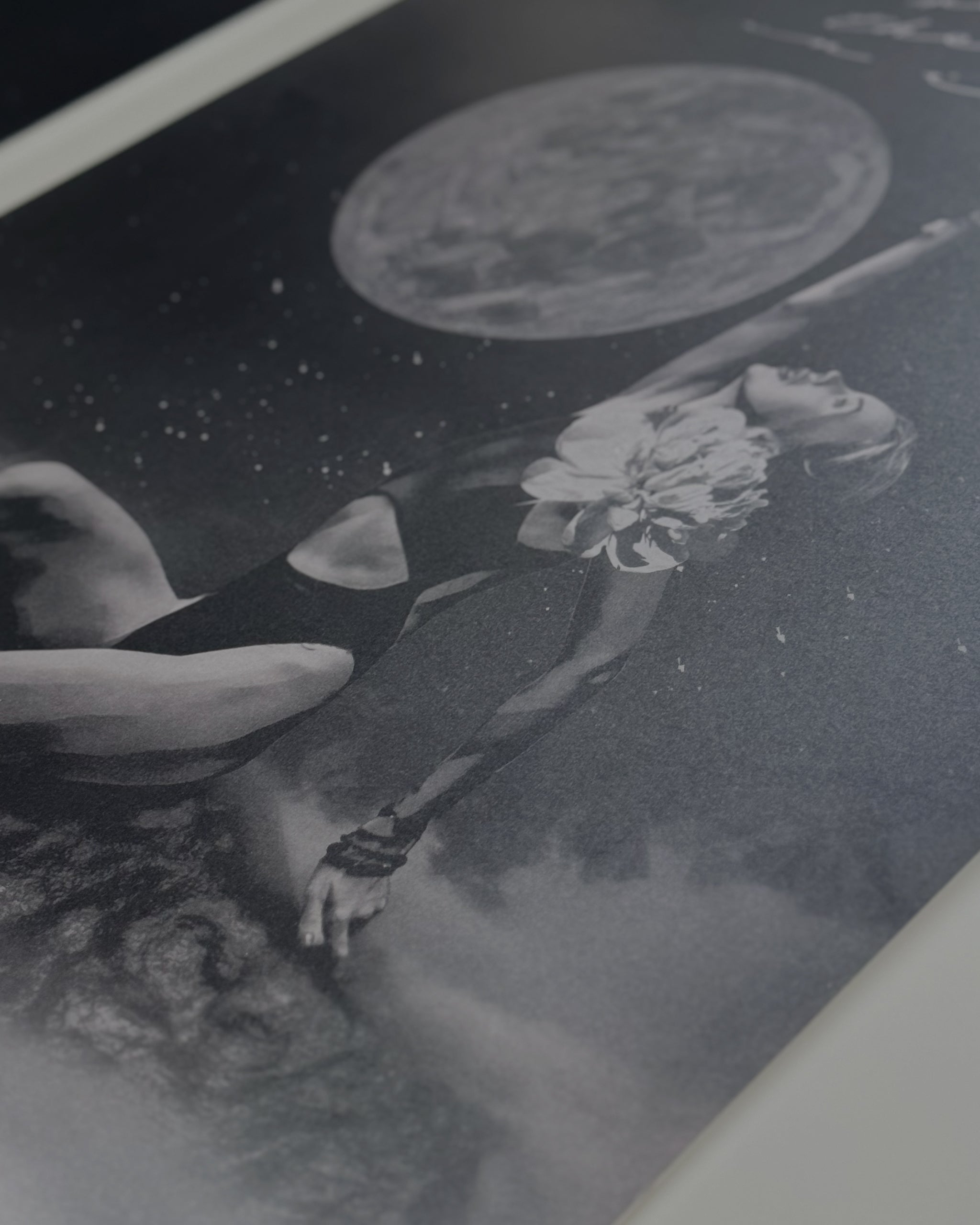 Black and white dreamscape art of a woman reaching towards the moon