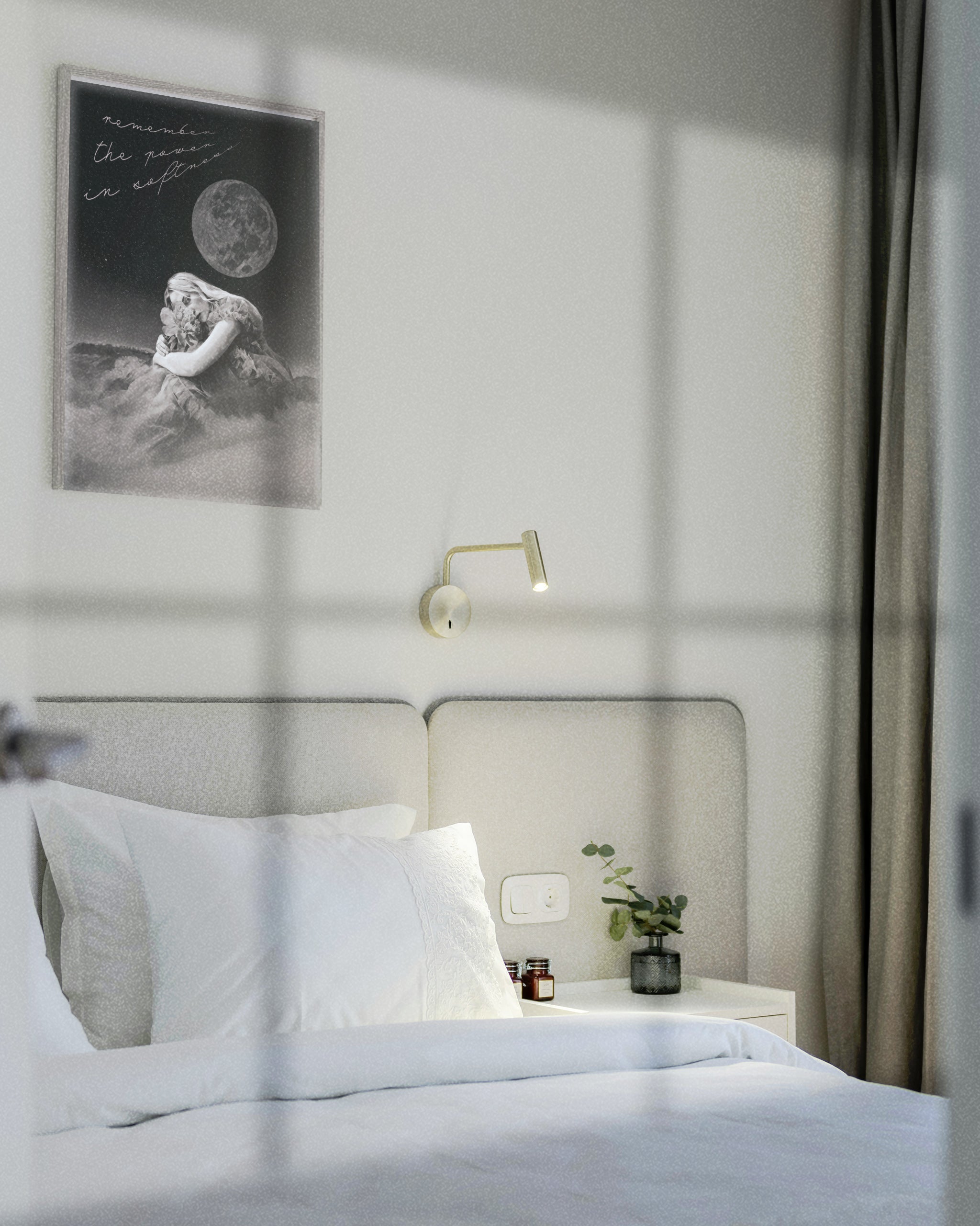 female energy dream art displayed in a grey frame on a wall in a minimalist white bedroom over a white bed