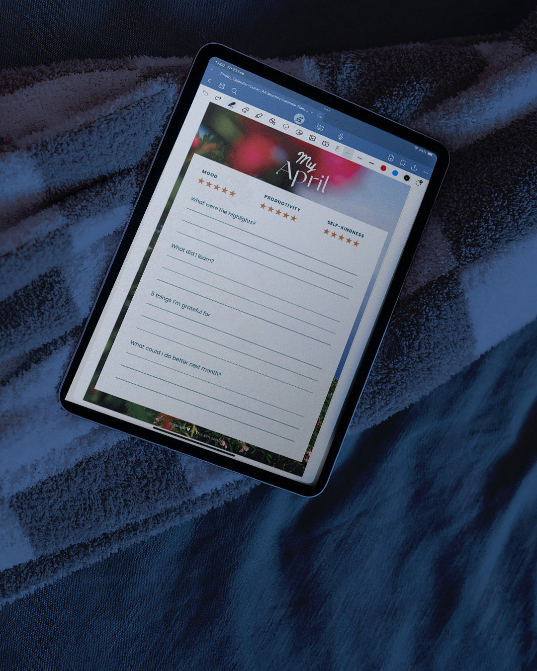 the digital planner compatible with goodnotes, shown in the goodnotes interface on an ipad, positioned on a blanket