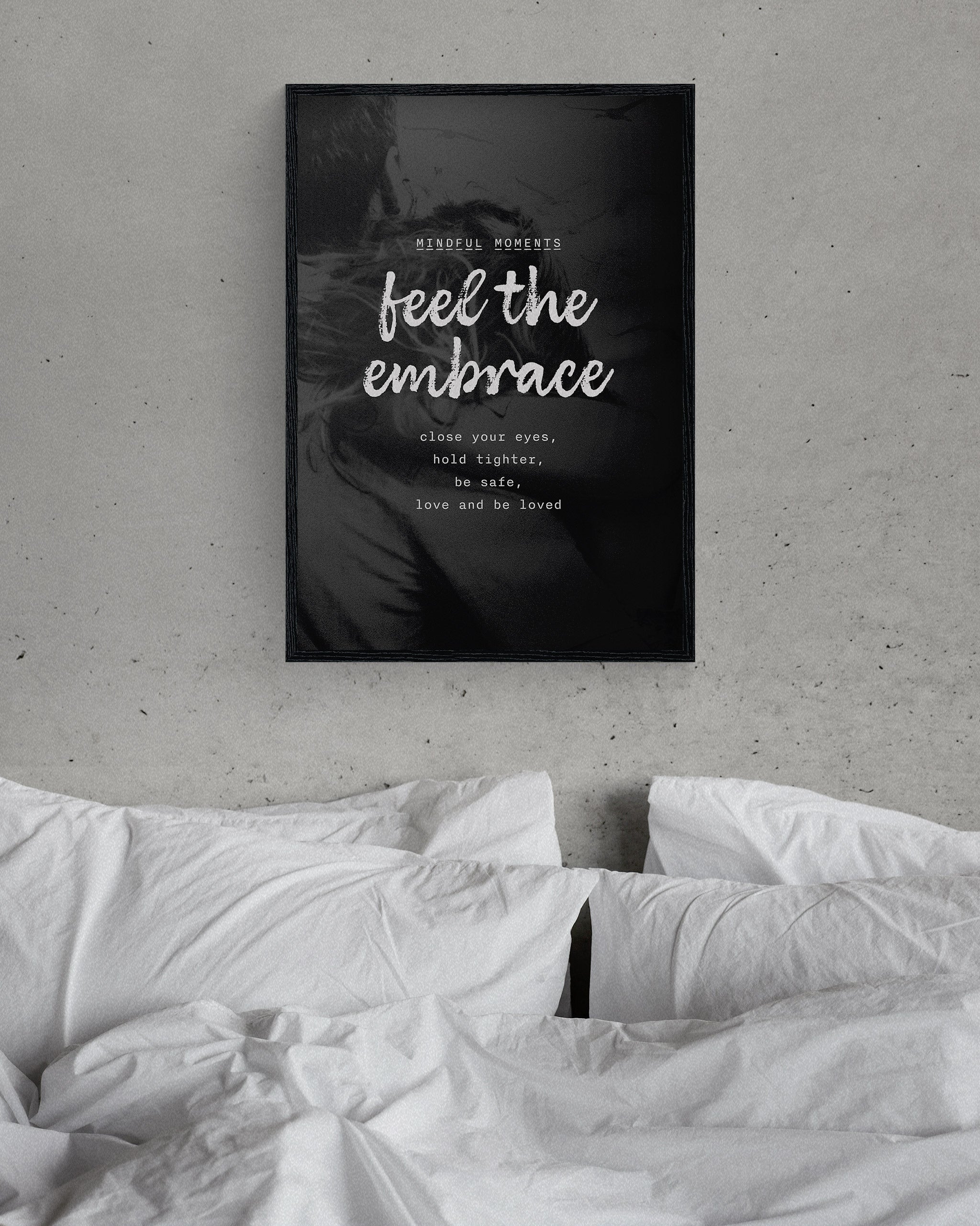 modern wall art on love in a simple black frame, on a minimalist grey bedroom wall above a bed with white sheets