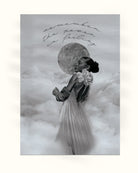 Black and white The Light Empath modern decorative wall art of a woman with a moon with text above her on a cloudy background 