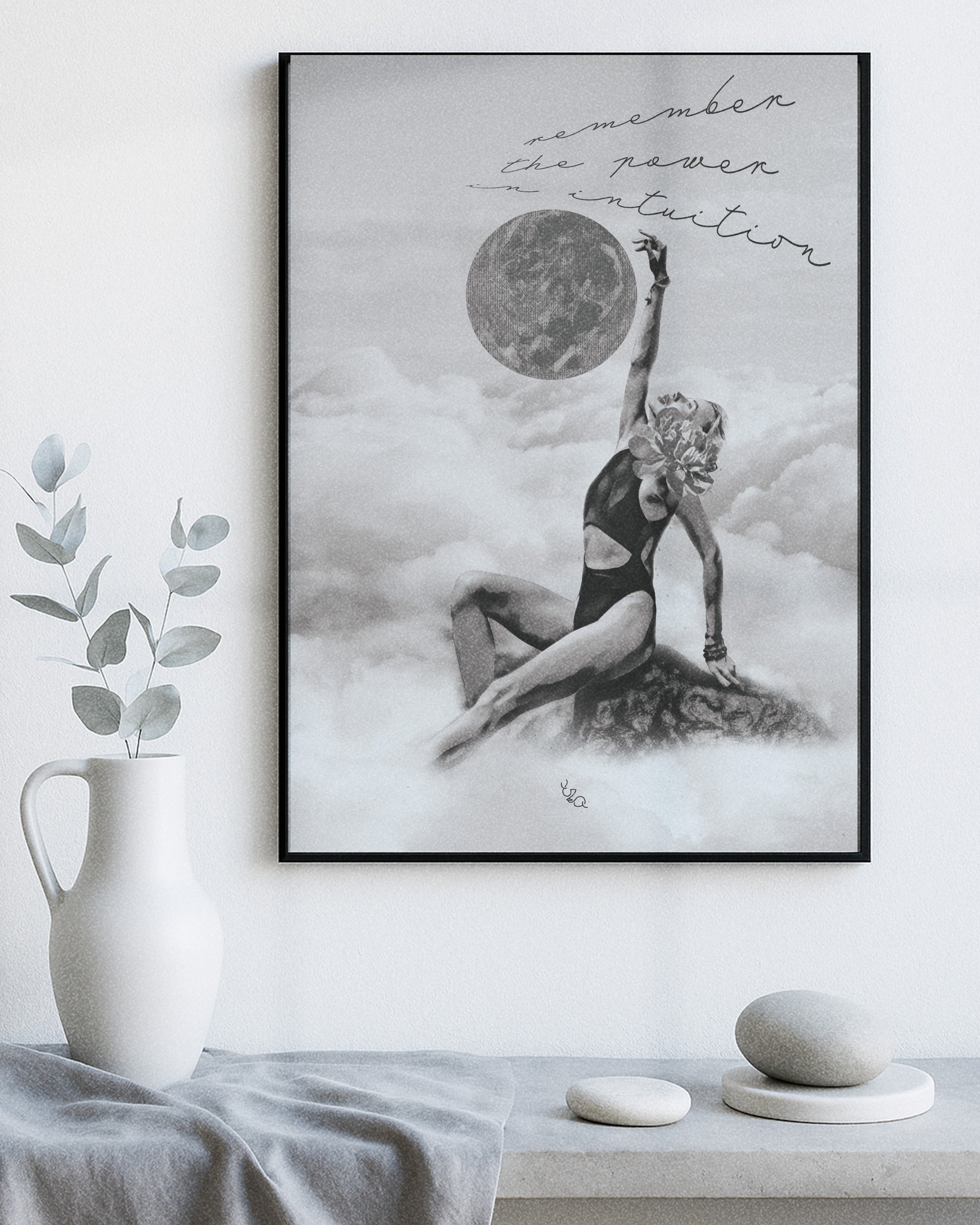 Framed women wall art for bedroom of a woman in a swimsuit with a moon above, on a white wall with decor items below.