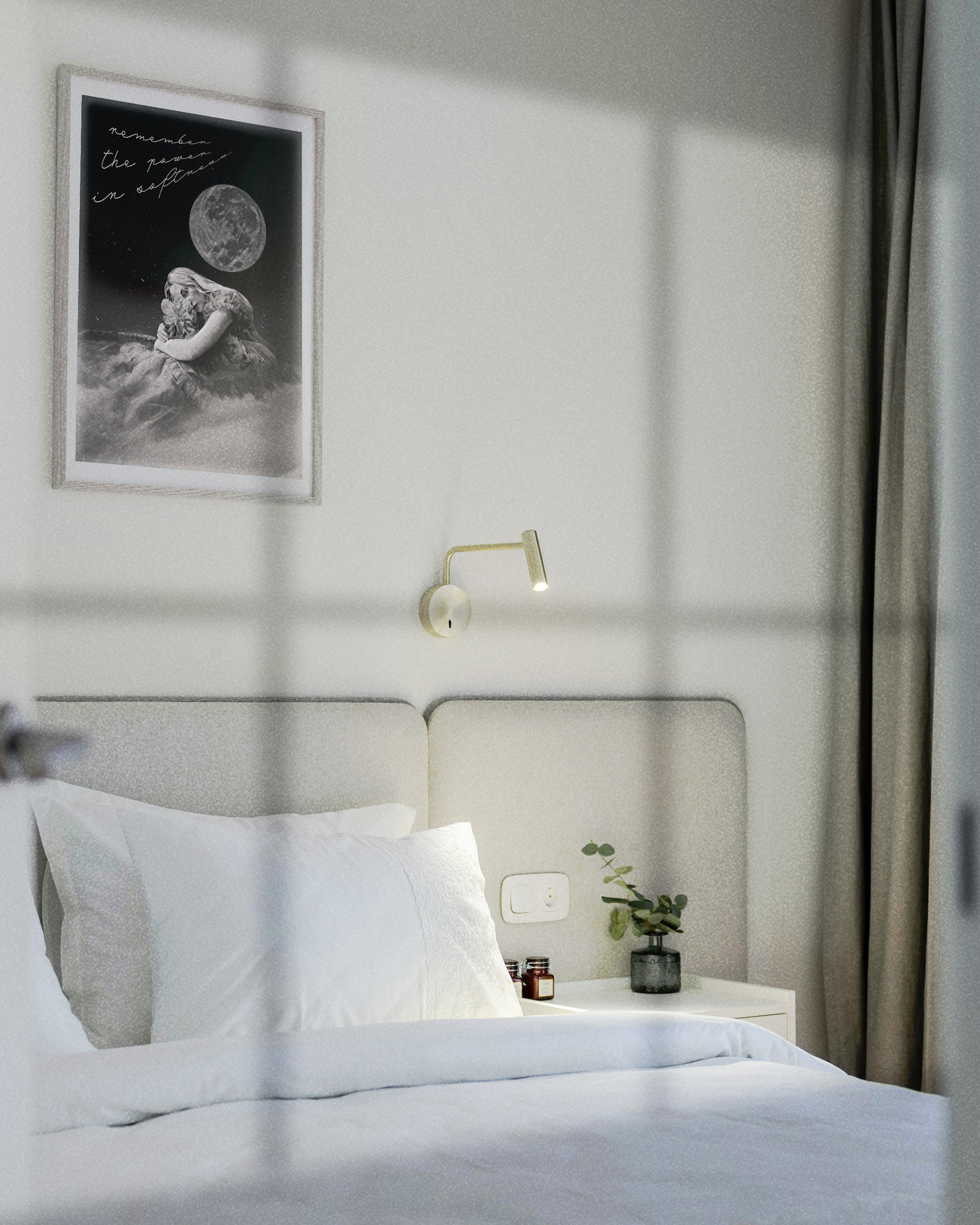 female energy dream art displayed in a grey frame on a wall in a minimalist white bedroom over a white bed