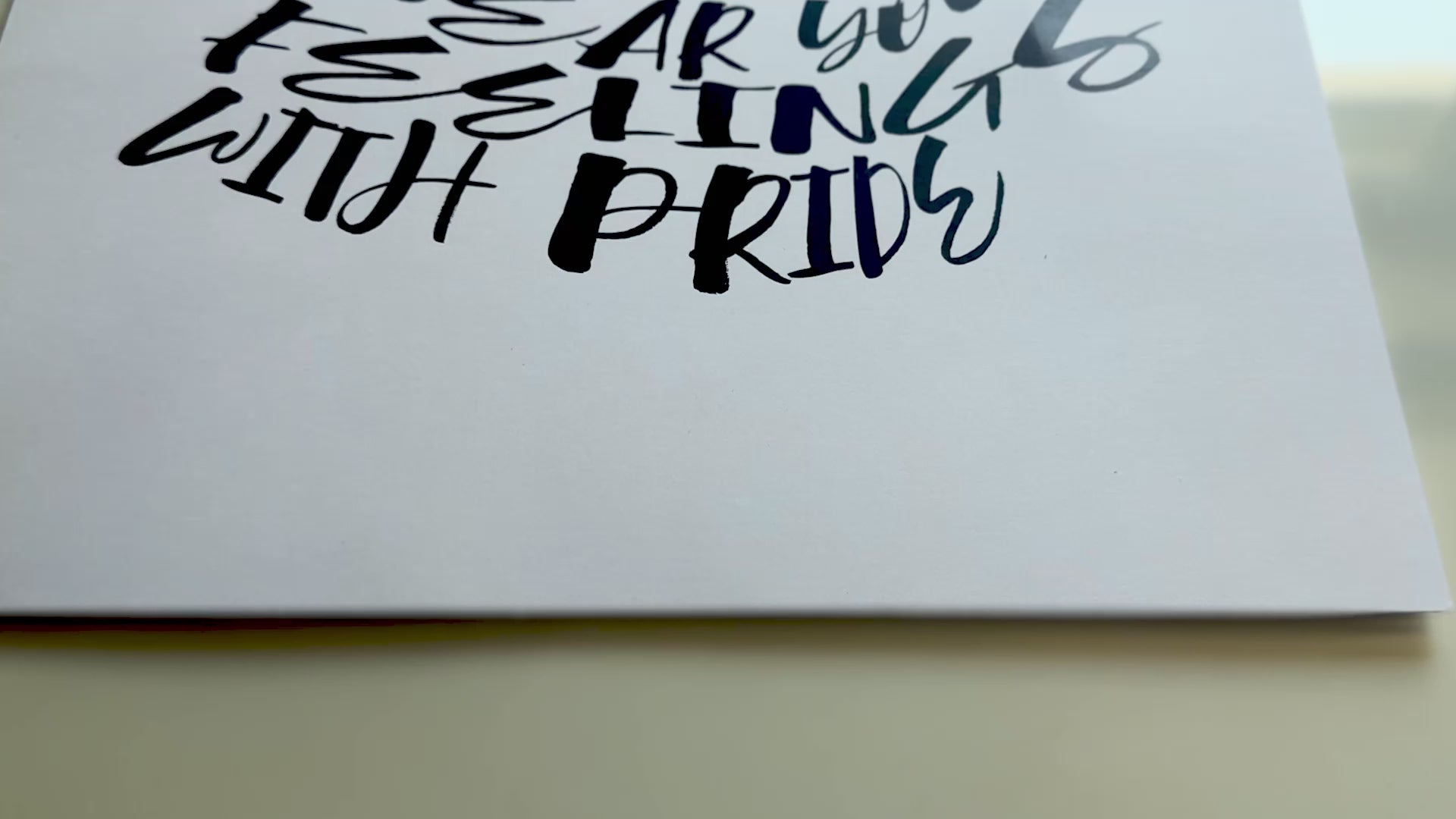 close up video of a self-acceptance poster featuring a woman with a dress made out of nouns that describe feelings, showing off the 200 GSM premium matte paper it's printed on