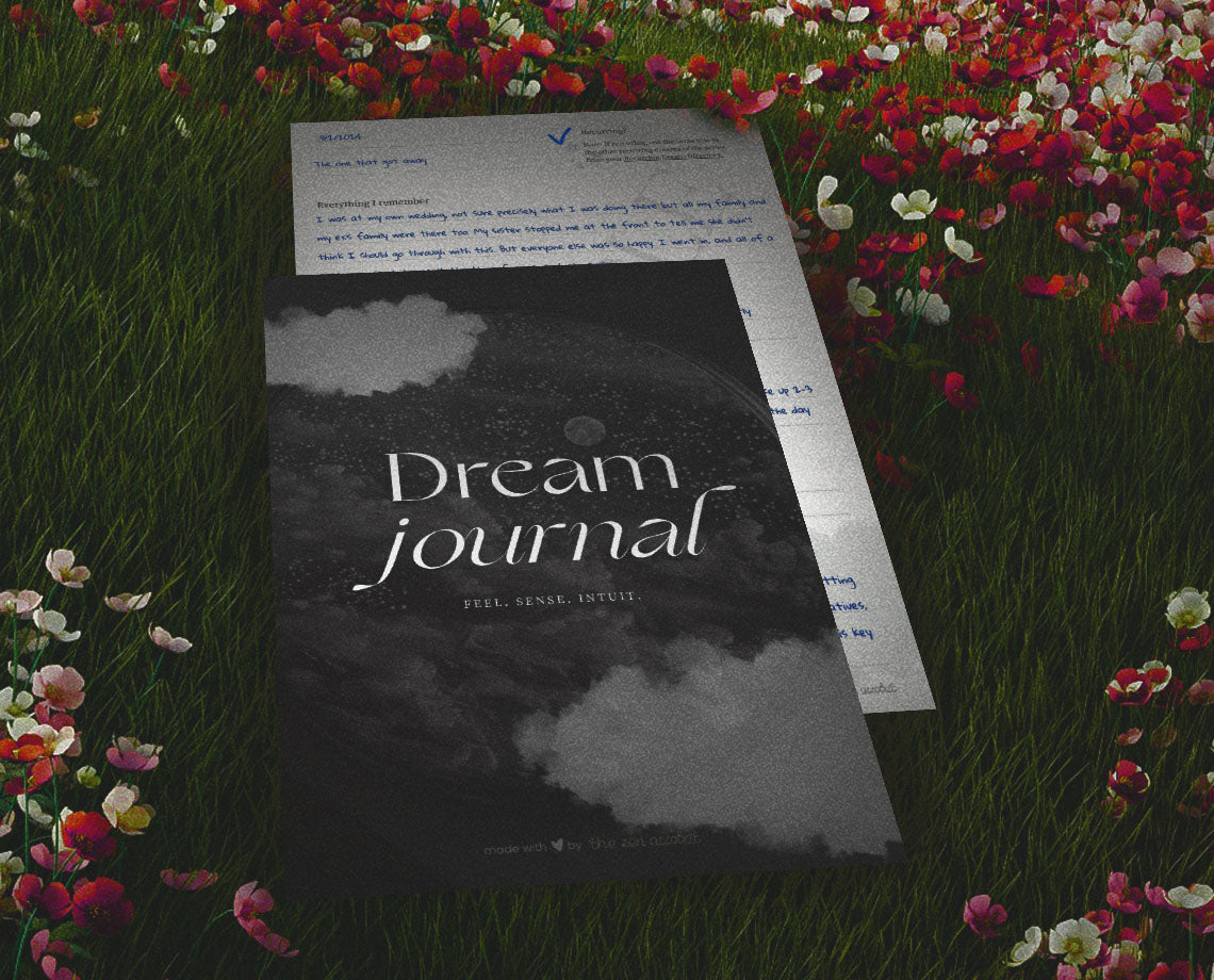 the zen acrobat dream meaning collection represented by the printable dream journal laying on a meadow of flowers